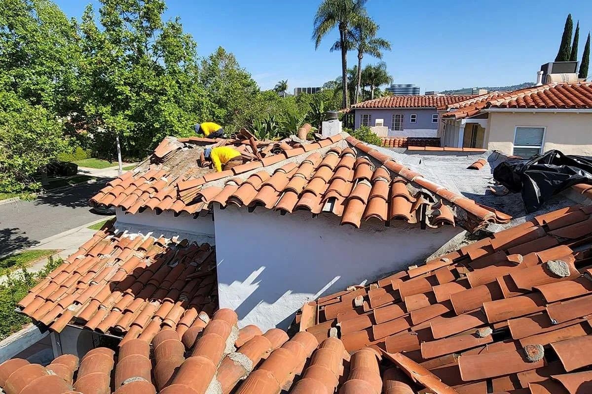 TMC Roofing crew restoring a Spanish clay-tile roof in Southern California