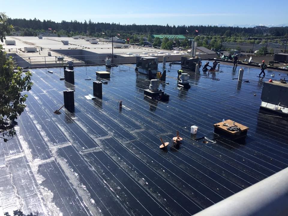 TMC Roofing crew on a large commercial flat-roof installation